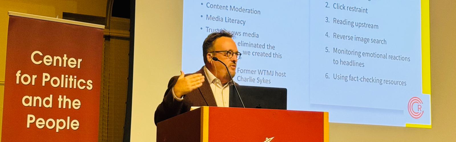 Prof. Michael Wagner on stage giving a talk at Ripon College.